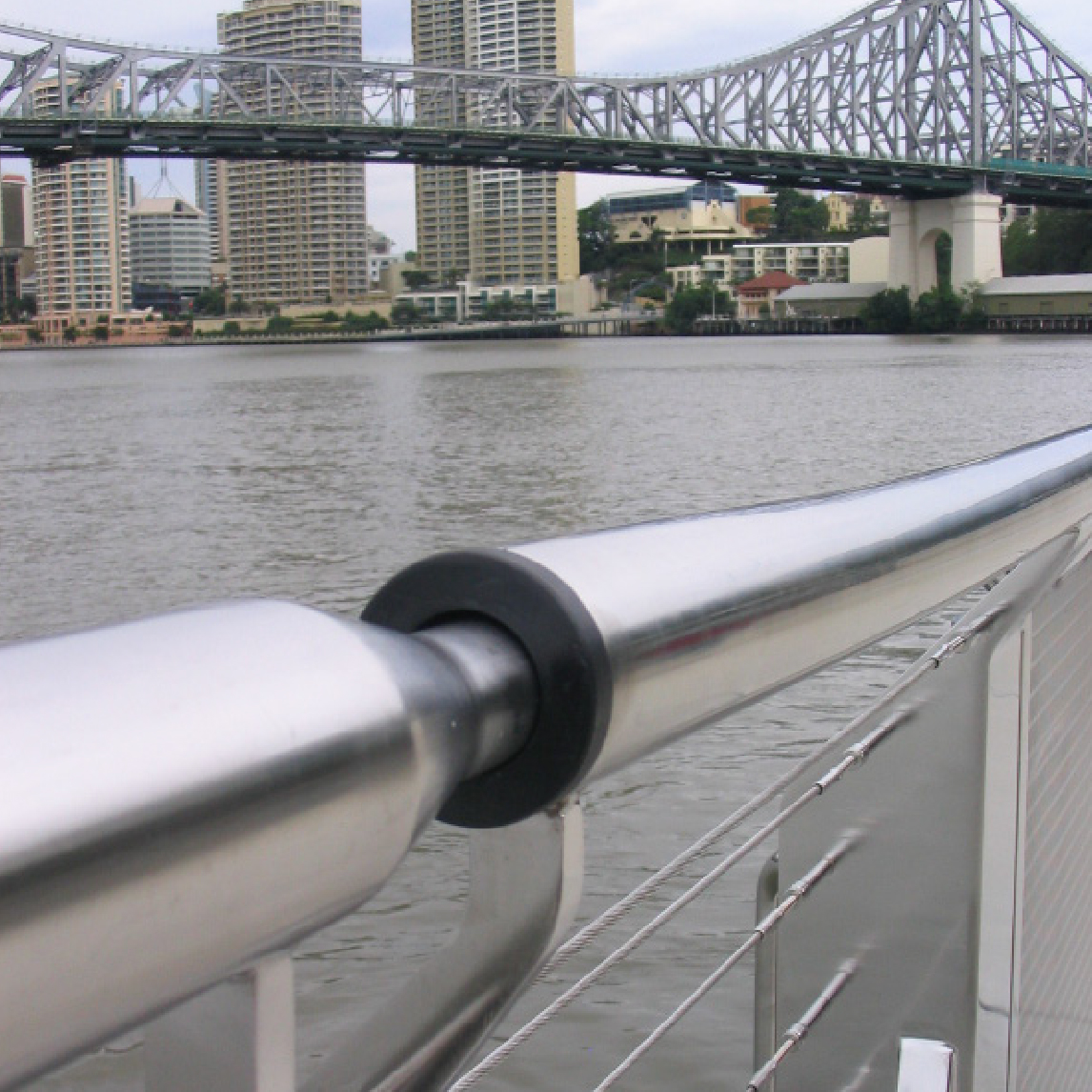 Preventing Coastal Corrosion Stainless steel railing system installed on bridge walkway with city skyline view